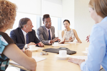 Fototapeta na wymiar Five Businesspeople Having Meeting In Boardroom