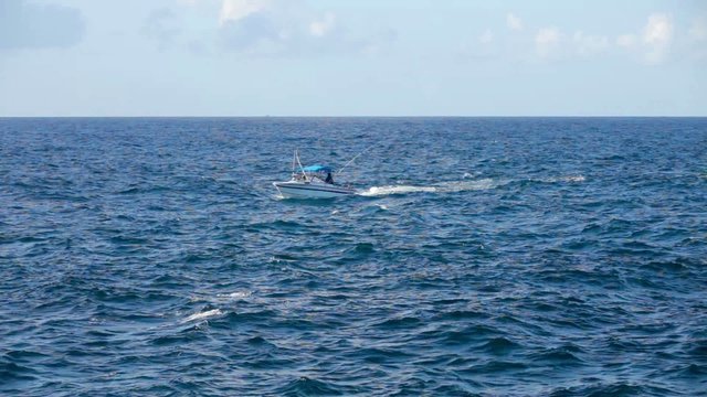 A fishing boat on the horizon in the distance