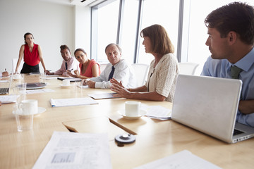 Group Of Businesspeople Meeting Around Boardroom Table