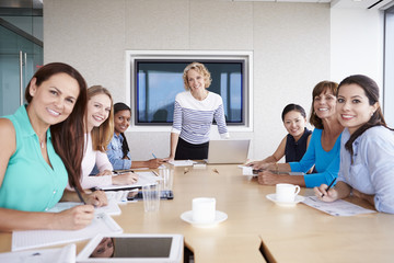 Group Of Businesswomen Meeting Around Boardroom Table