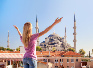 Merhaba, Istanbul! Girl welcomes the Blue mosque in Istanbul.