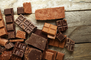 Set of chocolate on wooden table, closeup