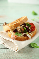 Tasty sandwich on wooden table, close up