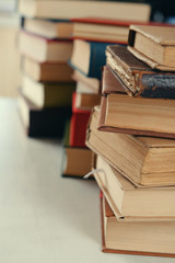 Stacks of books on table close up
