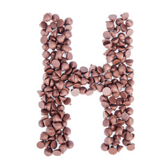Alphabet from chocolate chips on white background