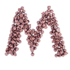 Alphabet from chocolate chips on white background
