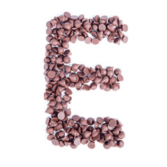 Alphabet from chocolate chips on white background