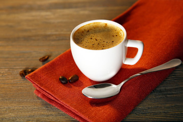 Cup of coffee on napkin on table close up