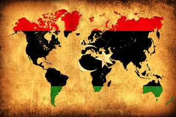 The flag of Libya in the outline of the world map