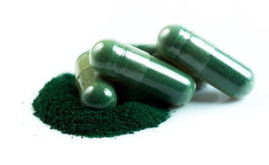 green herbal medicine capsule isolated on white background