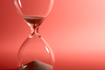 Hourglass on pink background