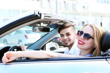 Young couple in cabriolet, outdoors