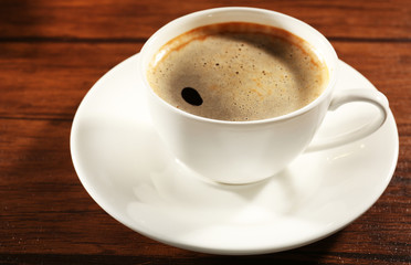 Cup of fresh coffee on wooden table, closeup
