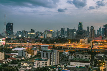 Fototapeta na wymiar Business Building Bangkok city area at night life with transportation way, logistic concept high angle bird eyes view 