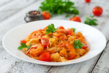 Fettuccine pasta with shrimp, tomatoes and herbs