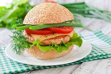 Sandwich with chicken burger, tomatoes, cheese and lettuce