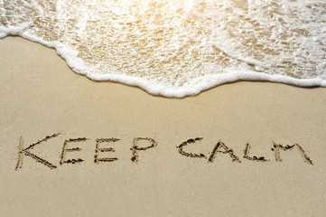 keep calm written on sand beach