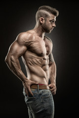Fototapeta na wymiar Muscular man - side view - on black background