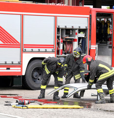 firefighters during a road accident with car parts