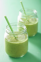 healthy green smoothie with spinach mango banana in glass jars