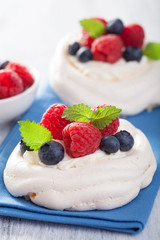 pavlova meringue cake with cream and berry