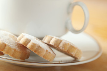 Italian Canestrelli cookies on the saucer of a cup