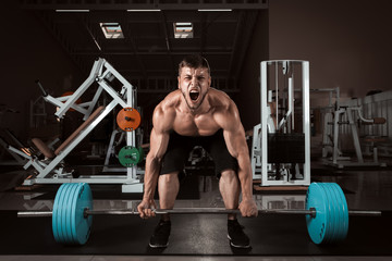 Fototapeta na wymiar Muscular Men Lifting Deadlift In The Gym