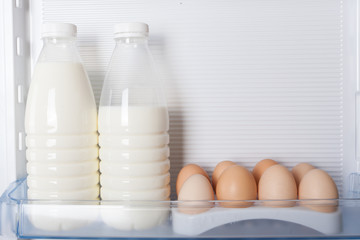 milk and eggs in door refrigerator