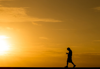 Silhouette people walking at sunset
