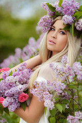 Spring portrait of a beautiful girl with lilac.