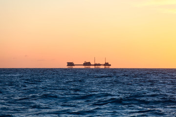 Oil platform in sunrise time
