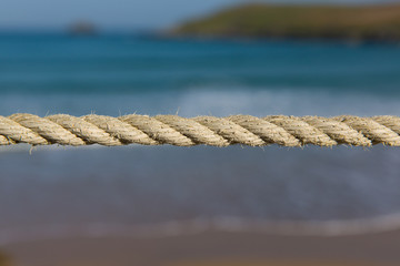 Rrope pulled tight background of blue sea and coast