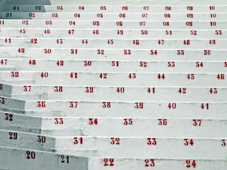 Naklejka premium red numbers in the stands of the stadium of football