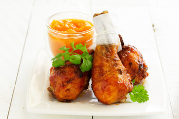 Roasted chicken legs with barbecue sauce with mango chutney.
