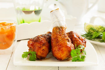 Roasted chicken legs with barbecue sauce with mango chutney.
