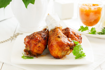 Roasted chicken legs with barbecue sauce with mango chutney.