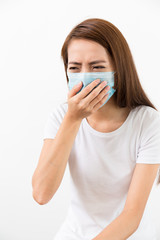 Young woman feeling unwell and wearing the mask