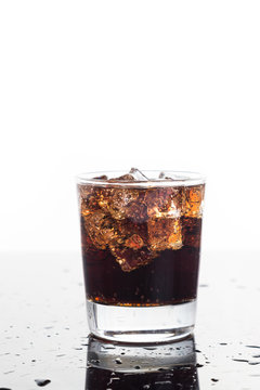 A glass of refreshing cold fizzy cola drinks