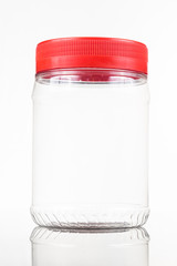 Translucent plastic PVC jar with red cover isolated in white