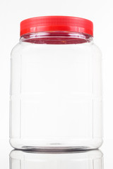 Translucent plastic PVC jar with red cover isolated in white