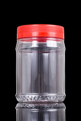 Translucent plastic PVC jar with red cover isolated in black