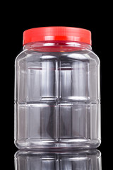 Translucent plastic PVC jar with red cover isolated in black