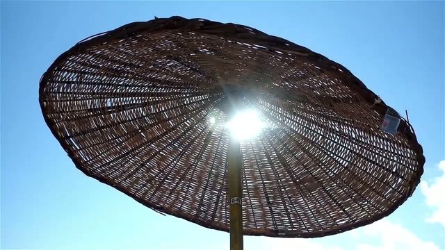 Beach parasol moves in the wind
