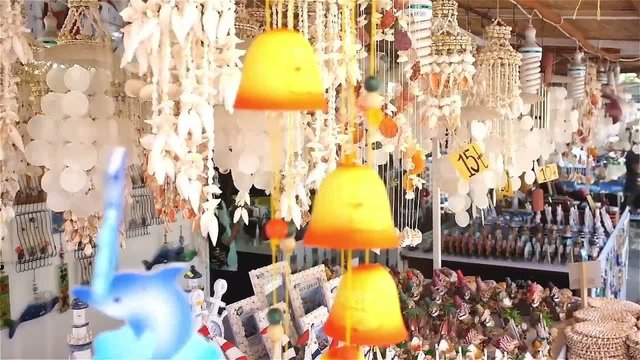 Decorative hanged gift objects moves with the wind on a market stall.