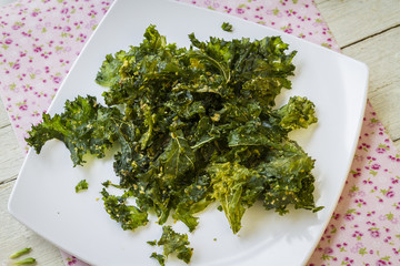 Kale chips on white plate