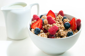 Bowl of muesli with red fruit.