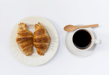 Croissant with black coffee on white background
