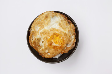 Rice with crispy fried egg with space on wood table background