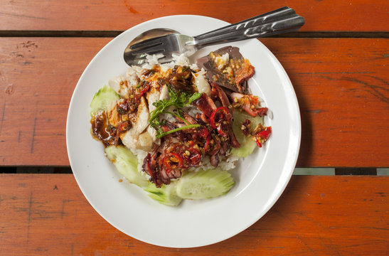 Thai style grill chicken with rice and spicy red chilli sauce 
