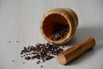 wooden mortar on the table with dry pepper